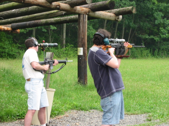 Barry with AR-15 using spotting scope to look at target, Doug with Dragunov