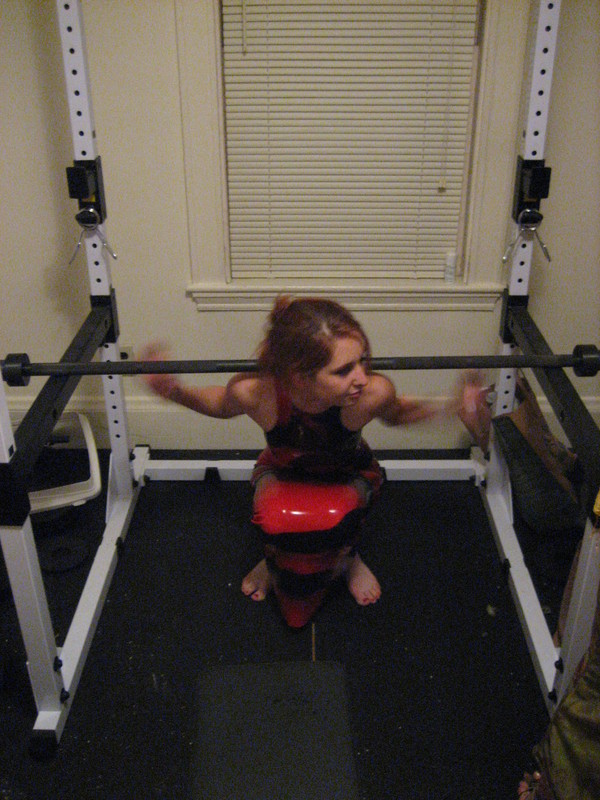 Calico demonstrating a deep squat in latex
