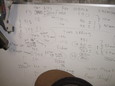 Motorcycle fork tuning notes on Milktree's whiteboard.
